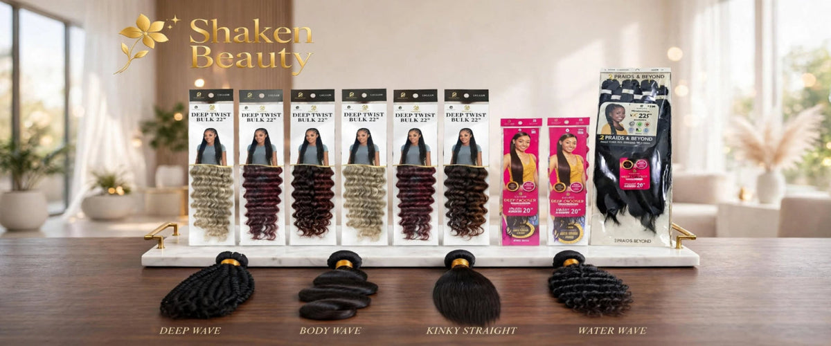 A Shaken Beauty hair extension display set on a wooden table in a bright room. The set includes multiple packaged hair wefts and braids in various textures and colors, with four loose black hair extensions displayed in front.